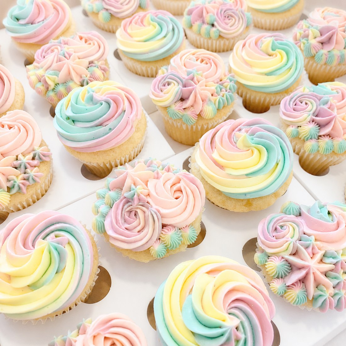 Cupcakes with pastel pink, mint, yellow and lilac swirls
