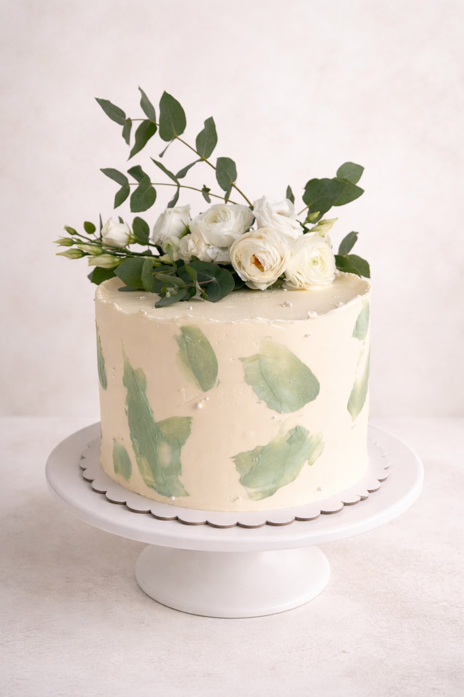 Ivory cake with sage accents and white wedding flowers